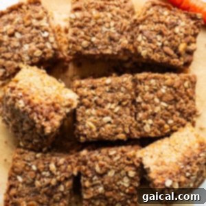 Spiced Carrot Coffee Cake 11 Carrot bars with oats and carrots on a cutting board, garnished with fresh mint.