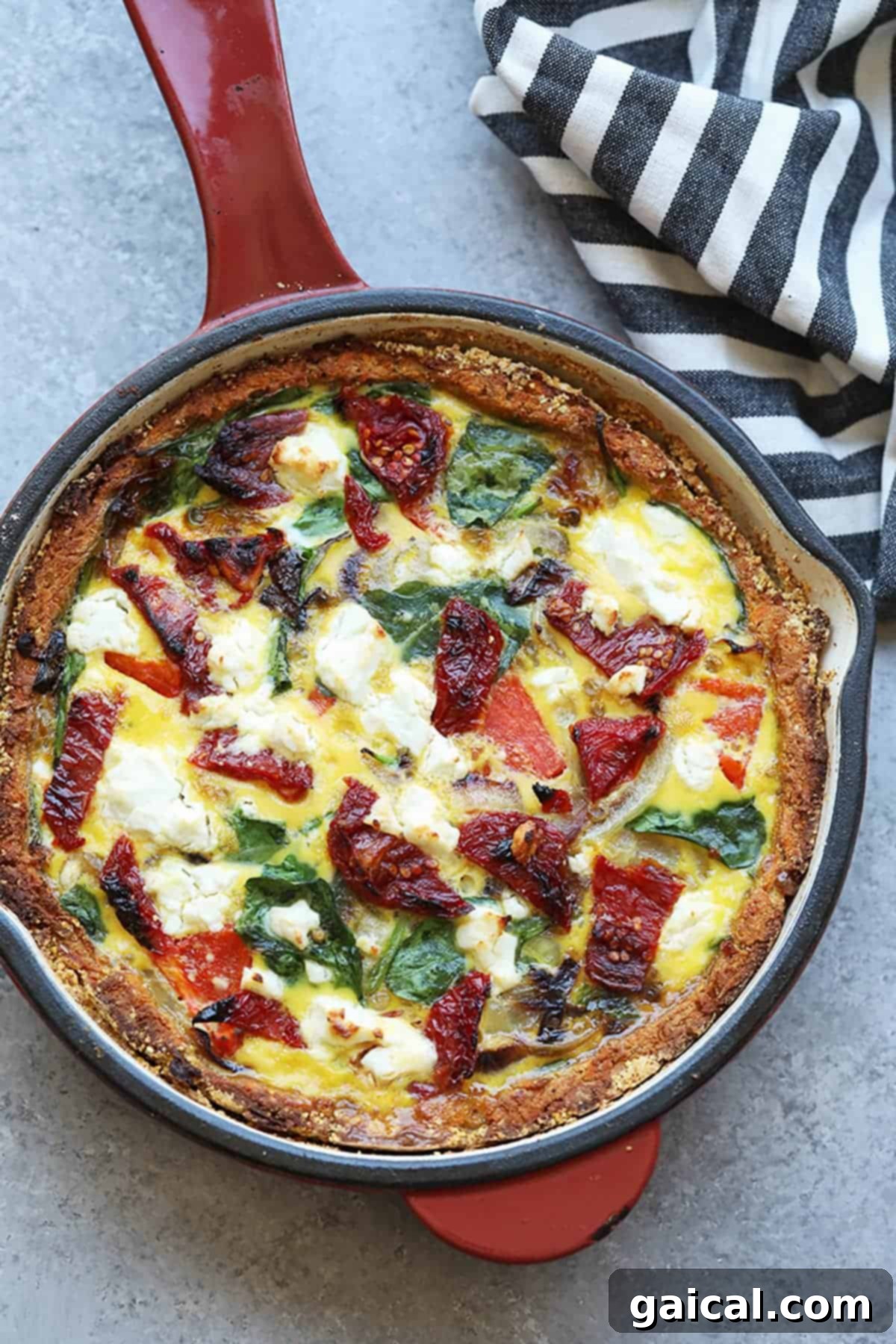 Vibrant Eats Collective: March 2024 5 a quiche with spinach and tomatoes in a skillet.