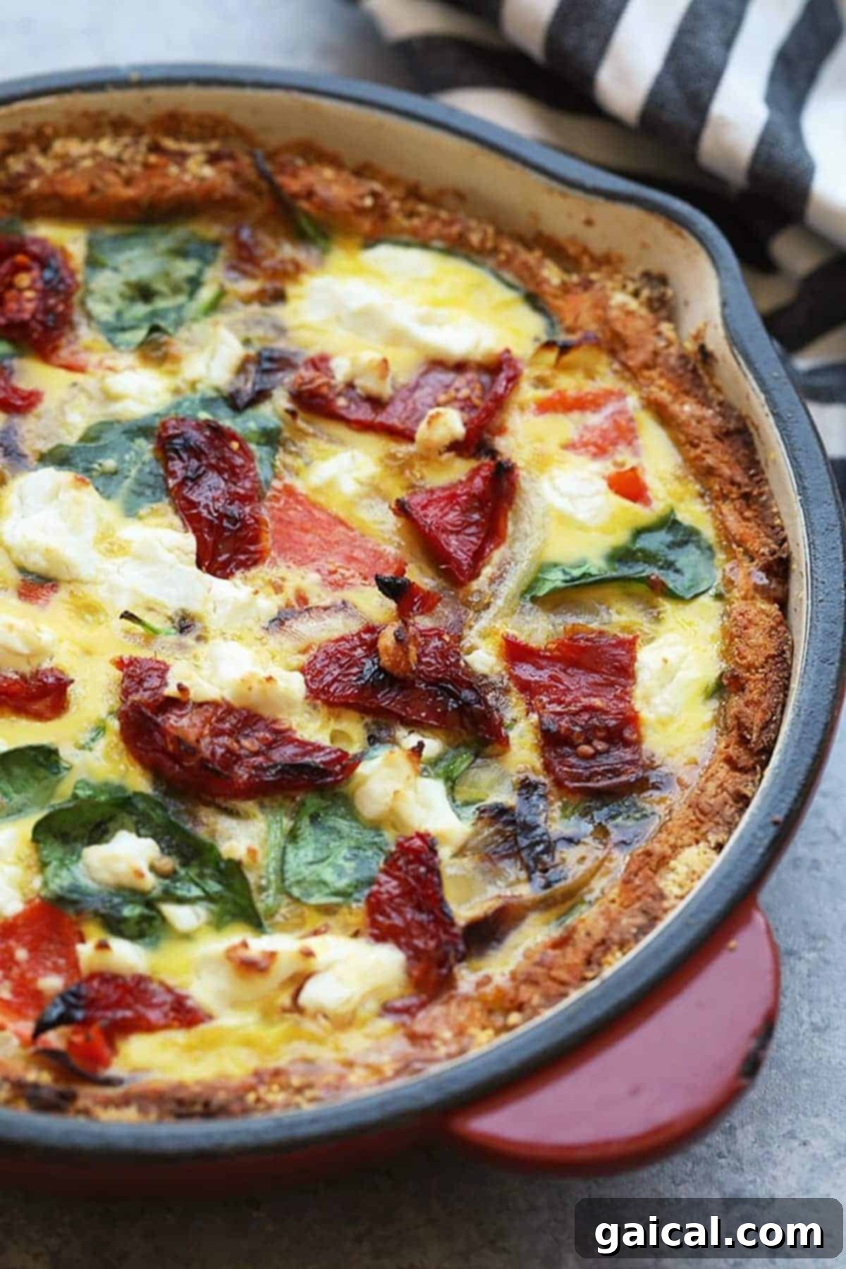 Vibrant Eats Collective: March 2024 6 a quiche with spinach and tomatoes in a cast iron pan.