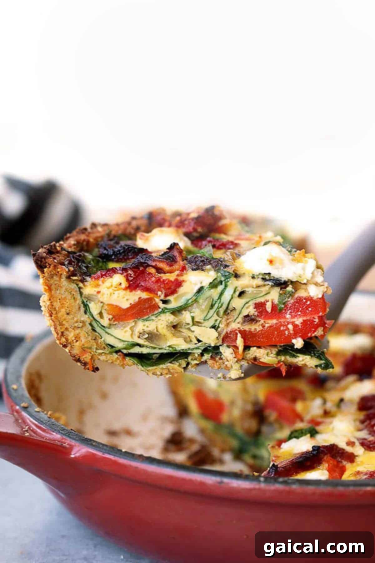 Vibrant Eats Collective: March 2024 7 a slice of spinach and bacon quiche in a red skillet.