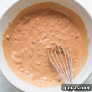 A bowl of freshly mixed Thousand Island dressing, ready for chilling to enhance its flavors.
