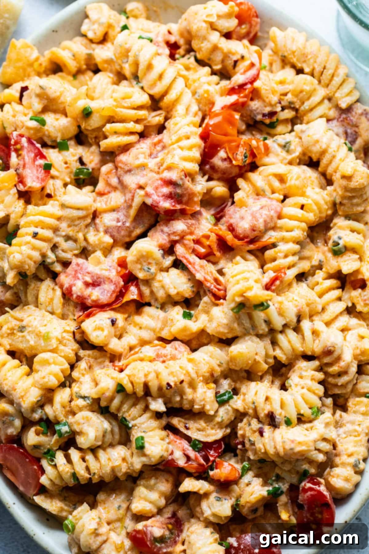 Creamy pasta salad with shrimp and diced vegetables.
