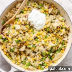 A skillet filled with corn and sour cream, ready for broiling.