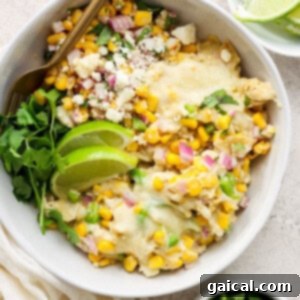 Mexican chicken and corn enchiladas in a white bowl, ready to eat.