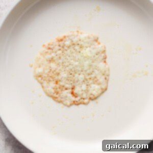 A single rice cake with scattered crumbs on a white plate.