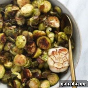 Crispy Roasted Brussels Sprouts 2 Roasted brussels sprouts in a glass bowl.