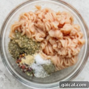 Cooked pasta with a variety of spices in a glass bowl.