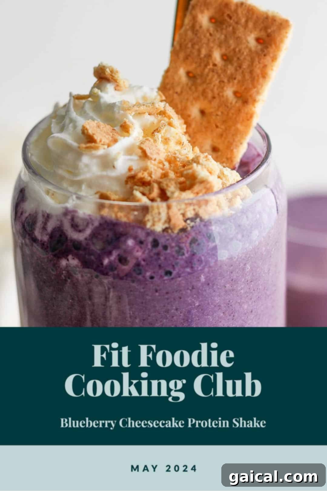Vibrant Plate Collective 2 A vibrant purple blueberry cheesecake protein smoothie in a glass, topped with whipped cream and fresh blueberries, ready to be enjoyed.