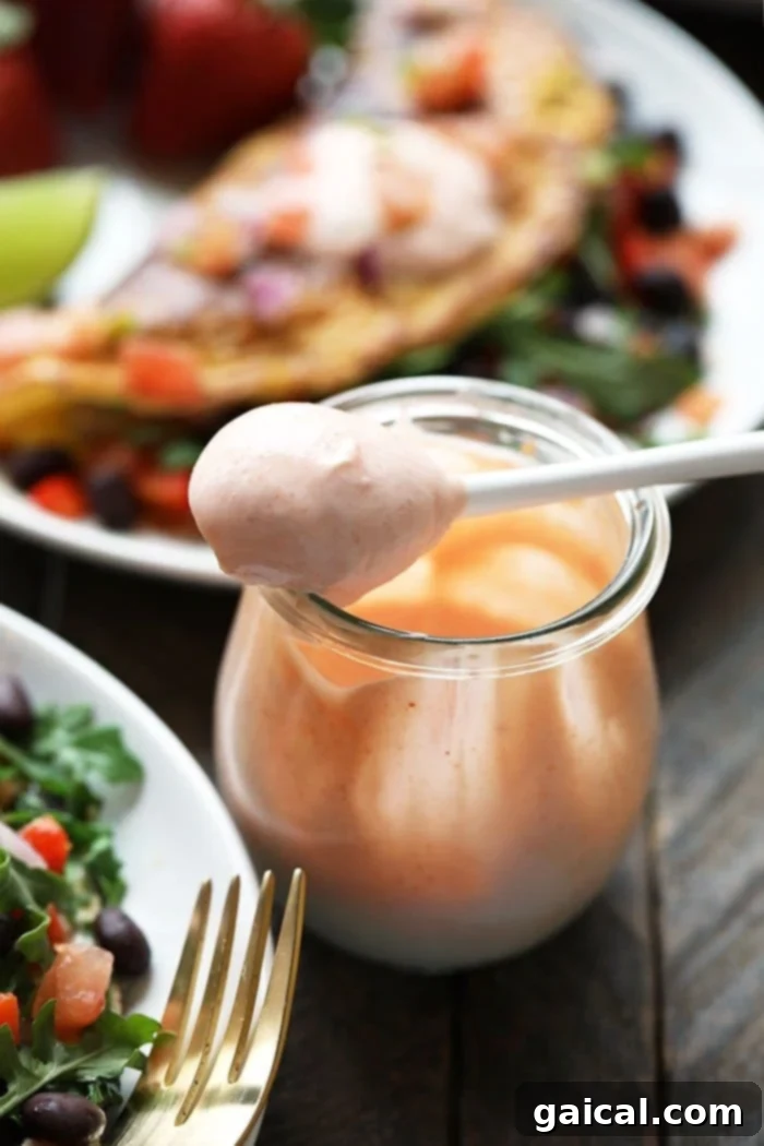 Garden Fresh Omelet 5 A small glass jar filled with a creamy, vibrant orange sauce, an ideal condiment for enhancing the flavor of a freshly prepared omelette.