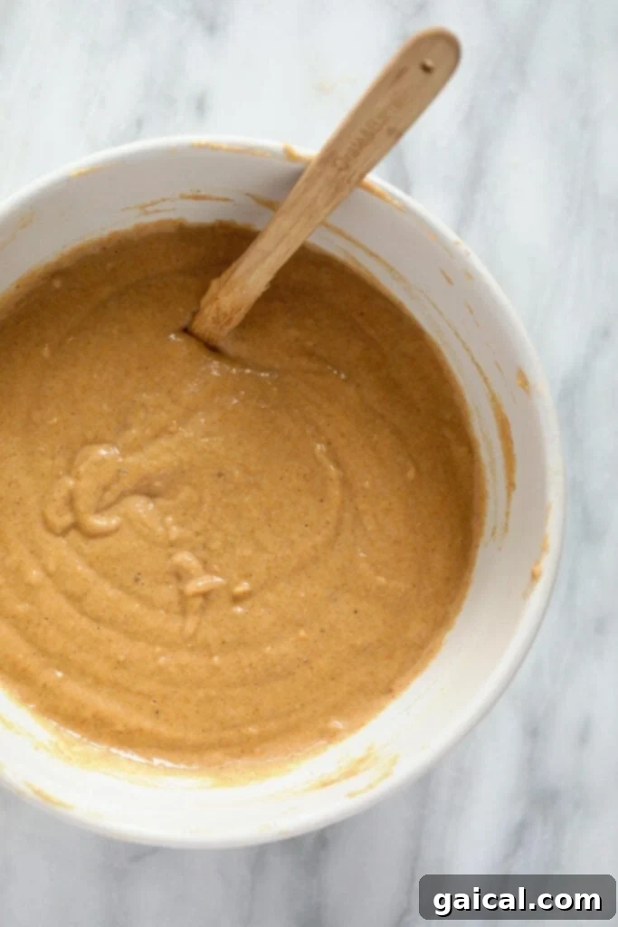 Sweet Potato Power Pancakes 5 Smooth, orange-hued sweet potato pancake batter resting in a mixing bowl.