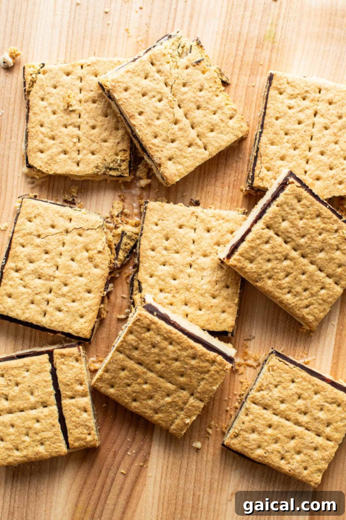 Peanut Butter Protein Smores Freeze 6 S'mores bars with a gooey chocolate filling and a creamy center, neatly arranged on a rustic wooden surface.