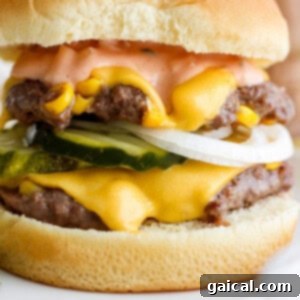 Confetti Corn Smash Burger 11 Close-up of a double cheeseburger with melted cheese, pickles, and onions, ready to be served.