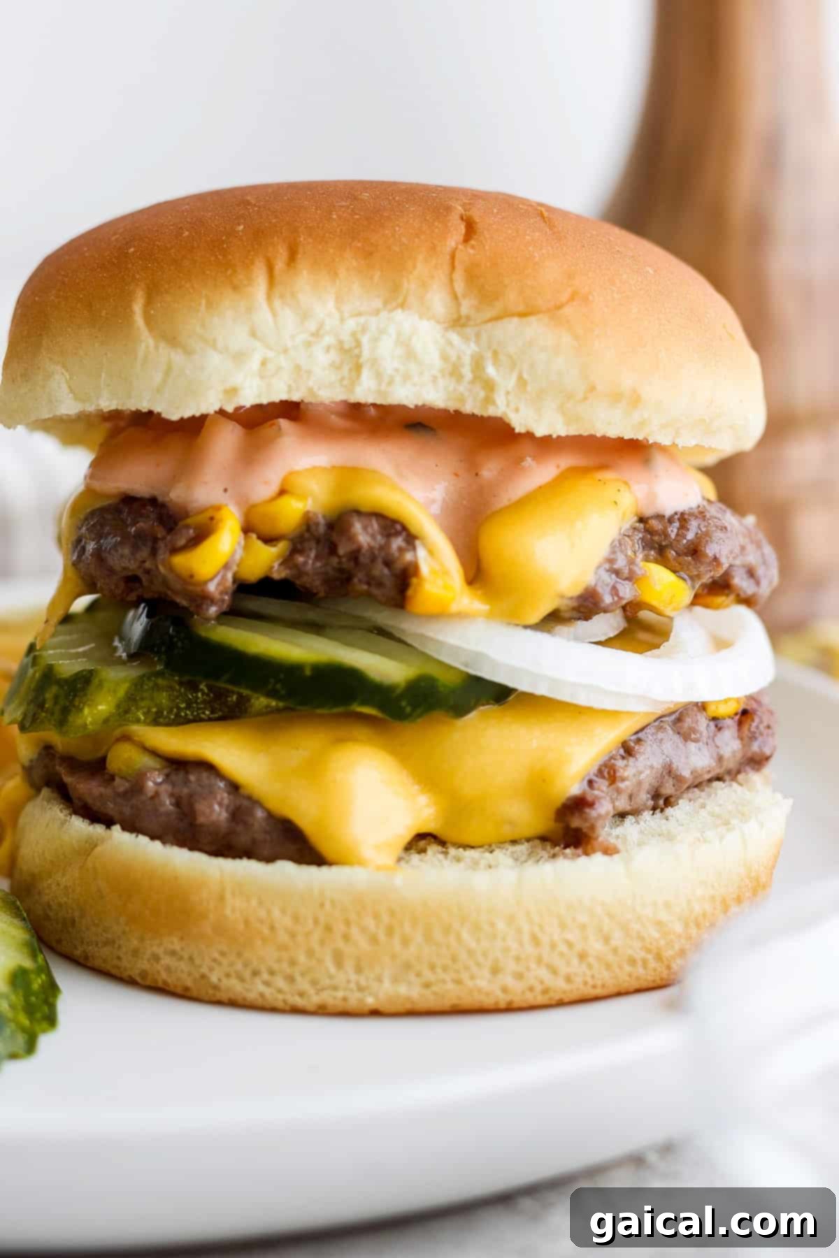 Confetti Corn Smash Burger 6 A vibrant, fully loaded double cheeseburger on a white plate, showcasing all its delicious layers.