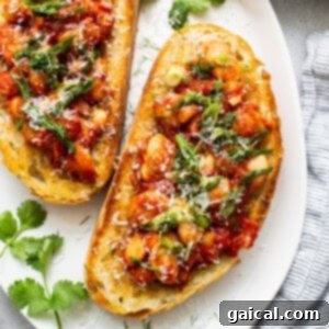 A vibrant close-up of bruschetta with chickpeas and tomatoes on a white plate, symbolizing fresh and flavorful ingredients.