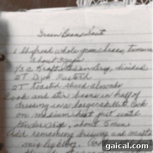 Mabel's Signature Spritz Cookies 3 Handwritten recipe for a green bean saute salad on lined paper, featuring fresh green beans, Italian dressing, Dijon mustard, and toasted sliced almonds. The easy-to-follow instructions guide you through creating this crisp and flavorful dish.