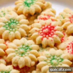 A plate of star-shaped cookies with red and green sprinkles.