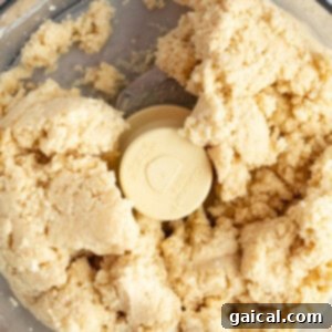 Fueling Frosted Pastries 10 Close-up of dough being mixed in a food processor.