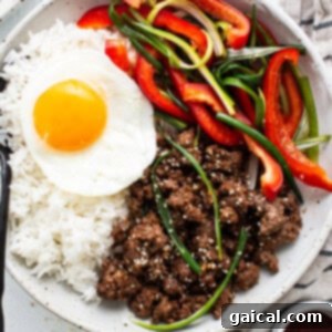 A bowl of Korean Ground Beef topped with fresh garnishes.