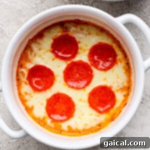 Personal Cottage Cheese Pizza Bowl 6 Baked dish topped with melted cheese and six evenly spaced pepperoni slices in a white ramekin on a textured surface.