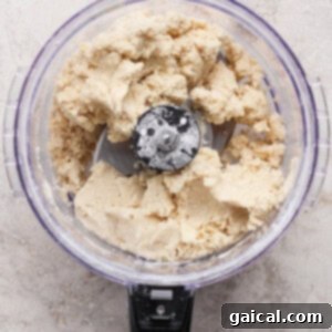 Gourmet Strawberry Toaster Tarts 11 A food processor filled with partially mixed dough sits on a light-colored countertop.