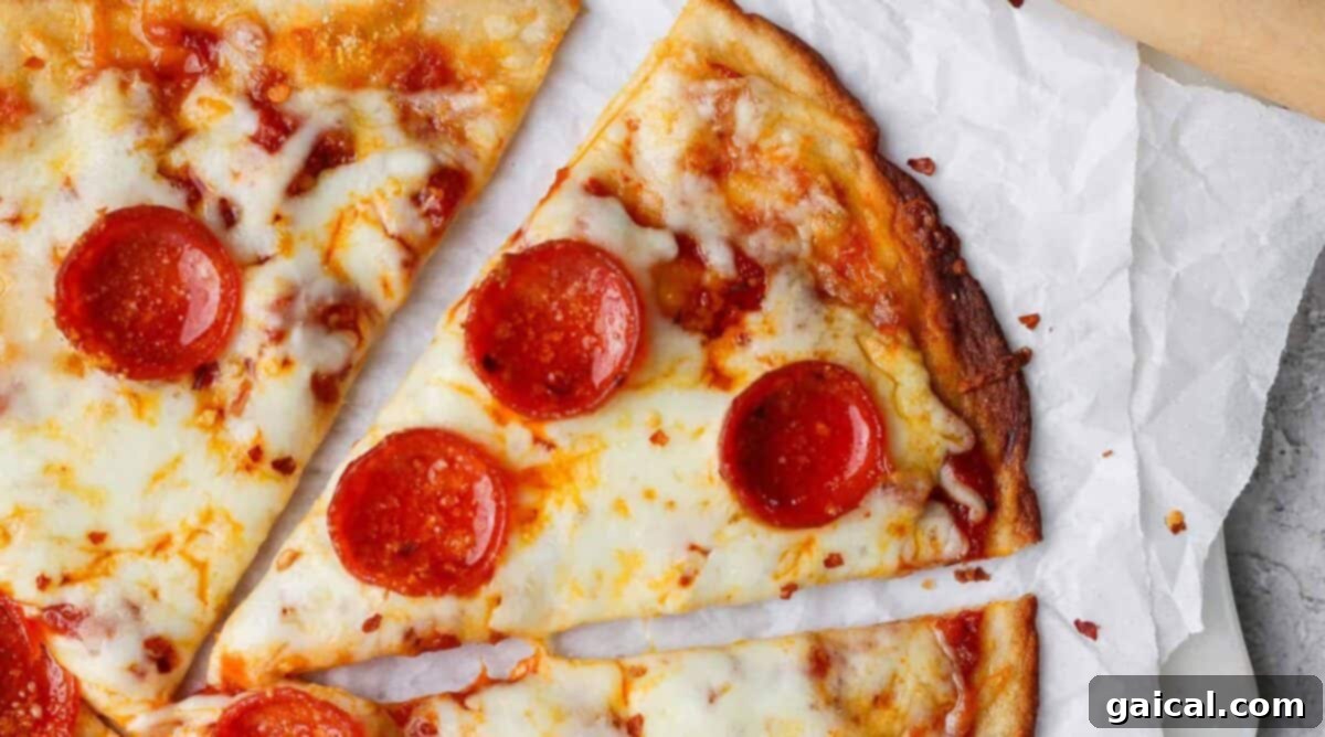 Slices of delicious pepperoni pizza, showcasing a healthy cottage cheese crust on parchment paper, ready to be enjoyed as a versatile savory dish.