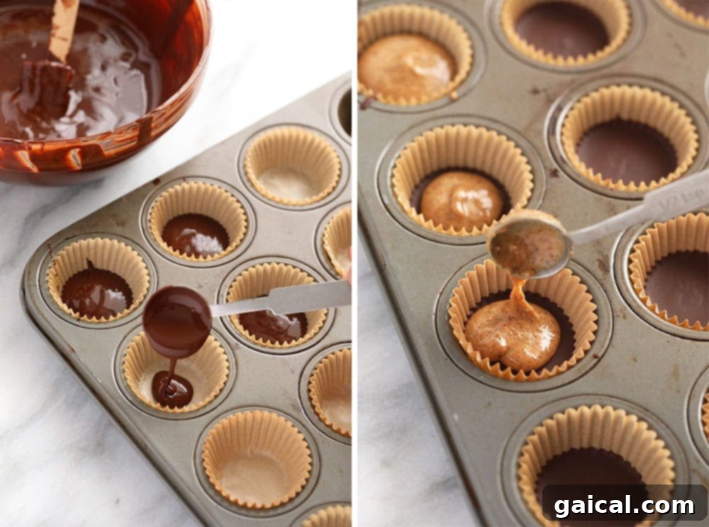 Almond butter cups neatly arranged in a mini muffin tin, ready for the next layer of chocolate.