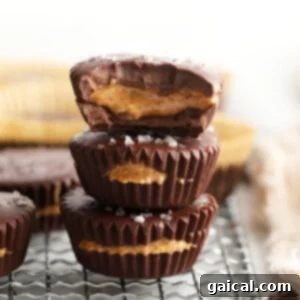 Stacked almond butter cups, showing a cross-section of the chocolate and almond butter layers.