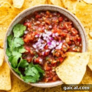 A bowl of fresh, vibrant homemade salsa, showcasing ripe tomatoes, onions, and cilantro, perfect for complementing chilaquiles.