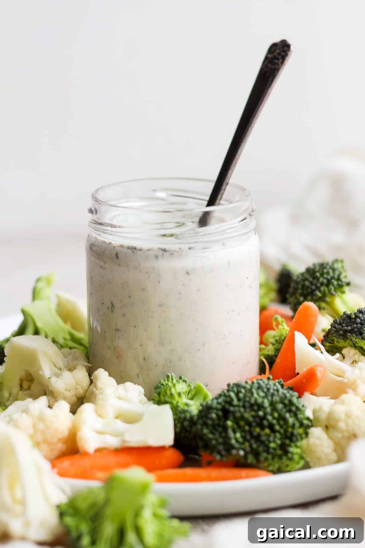 Smooth and creamy homemade ranch dressing in a clear jar. A jar of homemade ranch dressing, smooth and creamy, ready to serve.