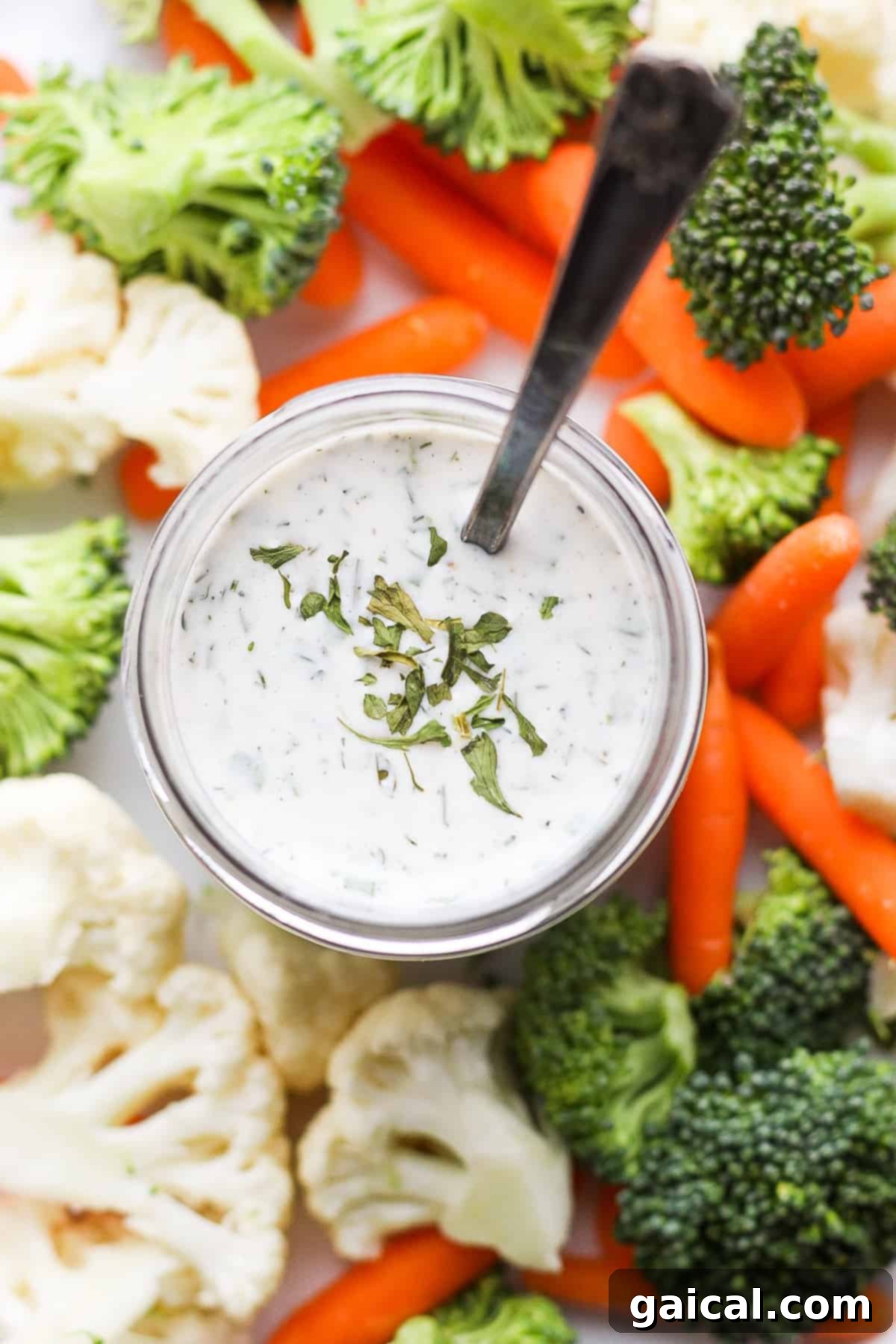 Storing homemade ranch dressing in a jar. A sealed jar of homemade ranch dressing ready for storage.