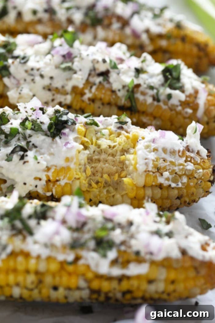 Charred Mediterranean Street Corn with Feta 2 Give the classic corn on the cob a major makeover with this Grilled Mediterranean Street Corn with Feta Cheese recipe, beautifully plated on a rustic wooden board.