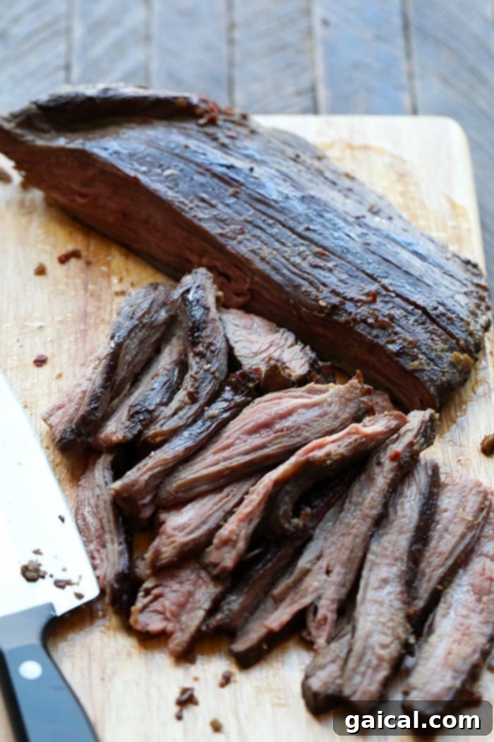 The easy process of preparing Mongolian beef for sous vide cooking. Flank steak marinating in a vacuum-sealed bag with Mongolian sauce, ready for sous vide.