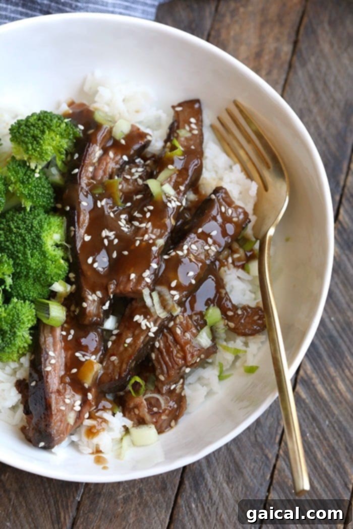 A mouthwatering serving of Mongolian Sous Vide Flank Steak. The finished Mongolian Sous Vide Flank Steak plated beautifully with rice and vegetables.