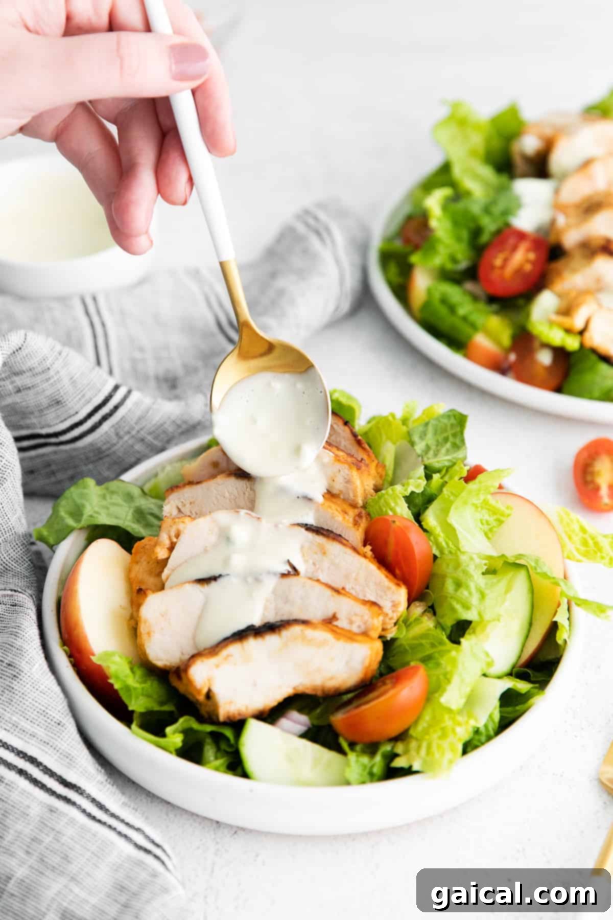 Close-up of a vibrant grilled buffalo chicken salad in a bowl.