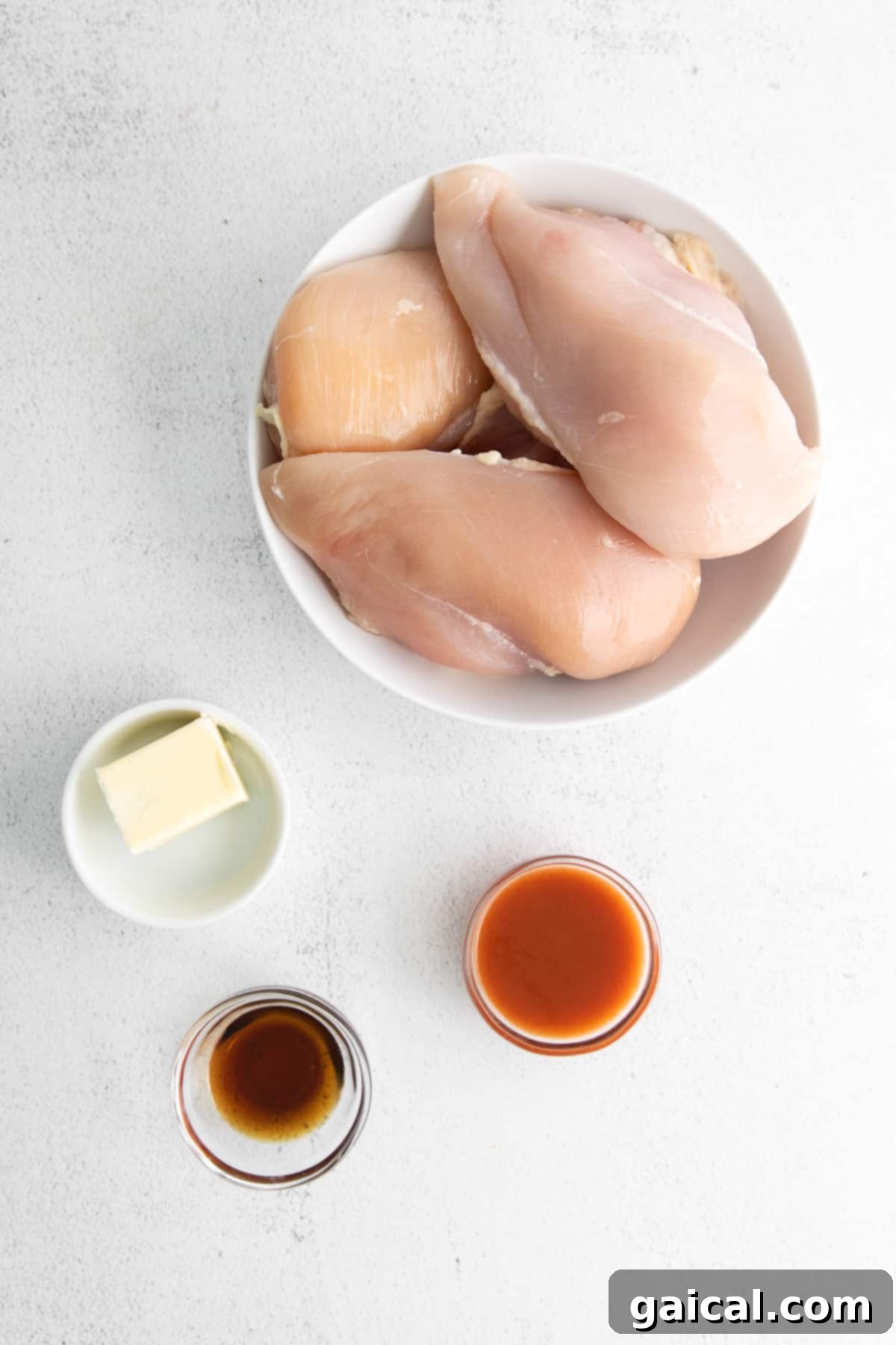 A close-up of the grilled buffalo chicken breast on a cutting board, ready to be sliced.
