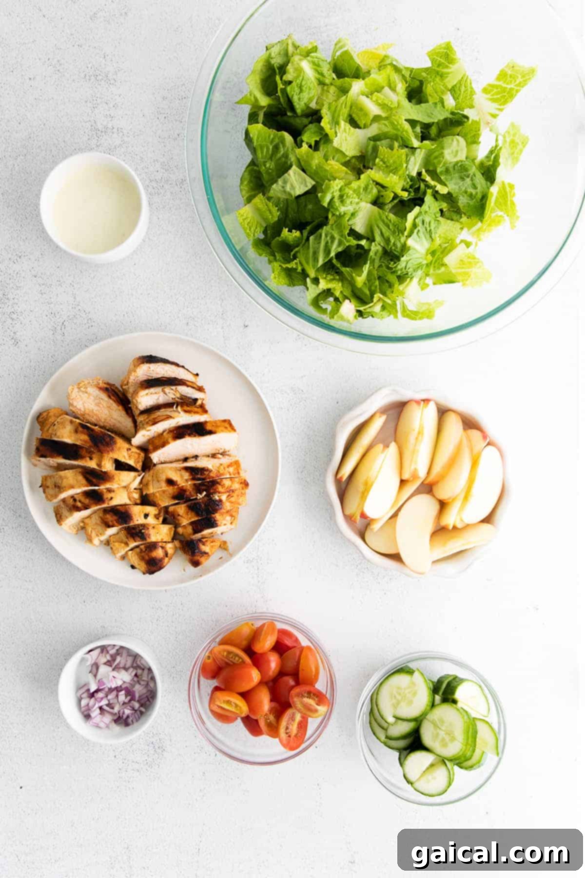 A vibrant, freshly prepared grilled buffalo chicken salad in a bowl.