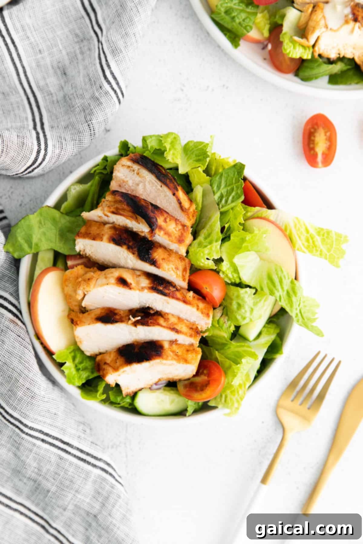 A close-up of blue cheese dressing being drizzled over a fresh salad.
