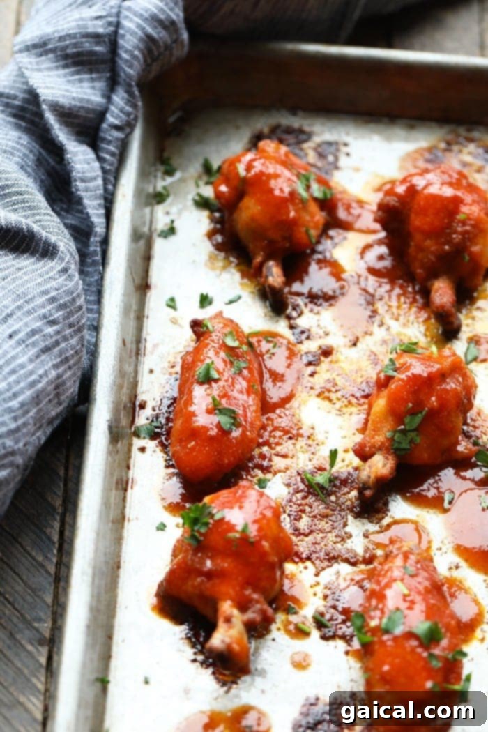 Healthy Baked Chicken Wings on Baking Sheet A baking sheet filled with freshly baked, healthy chicken wings, perfectly golden and ready to be tossed in their savory sauce.