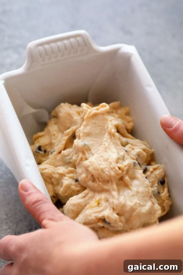 Nutty Chocolate Banana Dream Freeze 5 Peanut Butter Banana Nice Cream poured into a parchment-lined loaf pan, ready for freezing