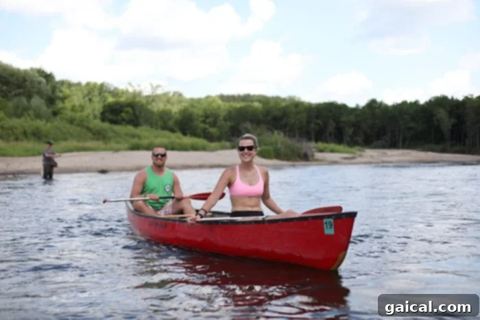 Paddle Cannon River and Savor Red Barn Pizza: Minnesota's Perfect Pairing 4 Friends laughing while canoeing down the Cannon River.