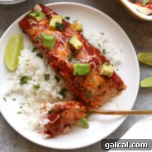 Nourishing Sweet Potato Chicken Enchiladas 2 A single serving of healthy chicken enchilada served over rice, garnished with avocado slices and fresh cilantro.