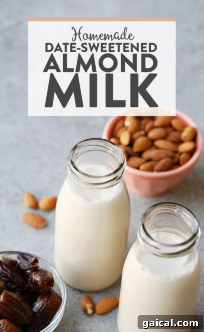 Freshly made homemade almond milk in a clear glass jug, showcasing its creamy texture, ready to be served or stored.