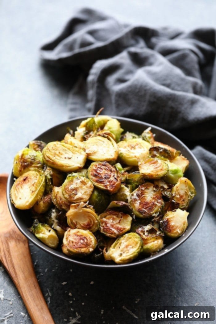 These roasted Brussel sprouts with parmesan are a great side dish staple for any time of year! All you need are 6 ingredients in order to make these crunchy, cheesy bites of heaven. Roasted Brussels Sprouts with Parmesan, beautifully golden and crispy, ready to be served.