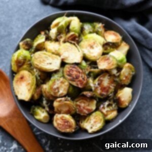 Roasted Brussels sprouts topped with parmesan in a bowl.