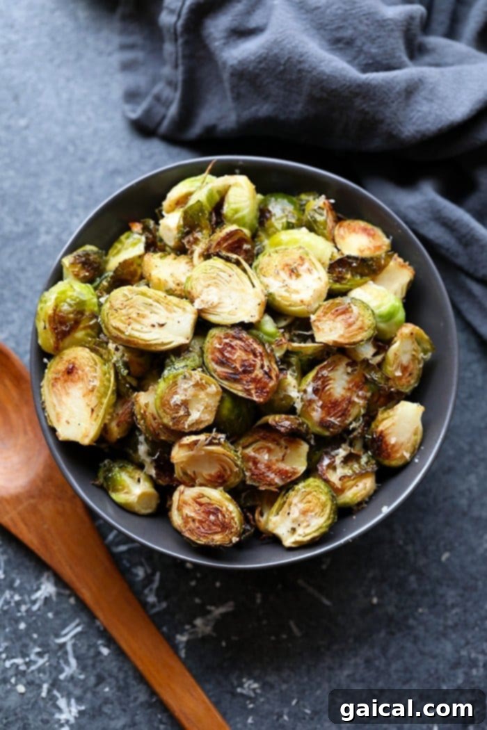 These roasted Brussel sprouts with parmesan are a great side dish staple for any time of year! All you need are 6 ingredients in order to make these crunchy, cheesy bites of heaven. A bowl filled with perfectly roasted Brussels sprouts, ready to be enjoyed as a delicious side.