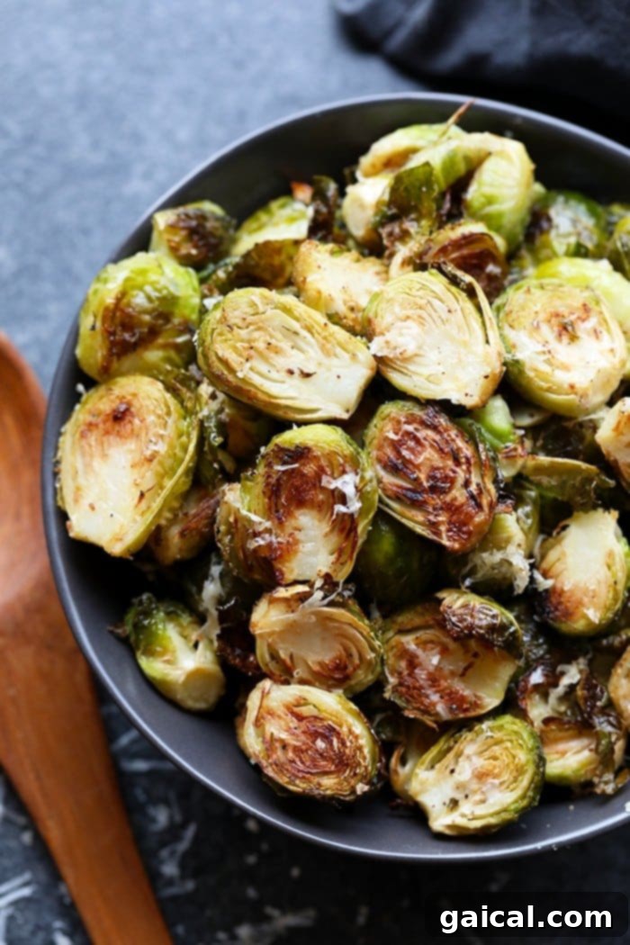 These roasted Brussel sprouts with parmesan are a great side dish staple for any time of year! All you need are 6 ingredients in order to make these crunchy, cheesy bites of heaven. A bowl of fresh, raw Brussels sprouts, ready for preparation.