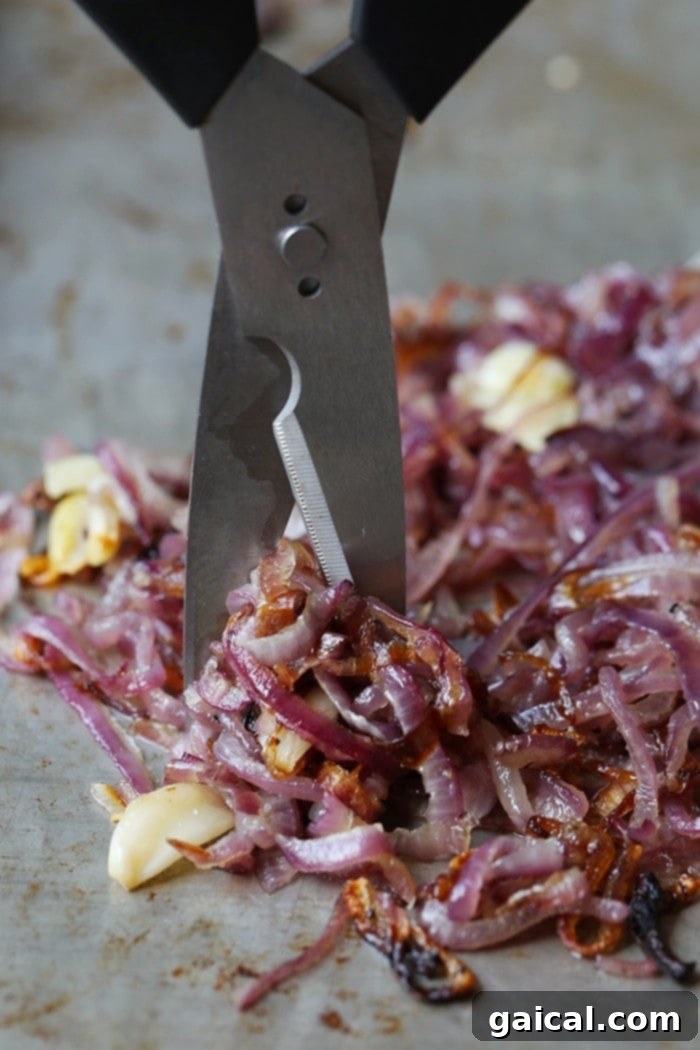 A small, inviting bowl of freshly made caramelized onions, ready to be enjoyed.