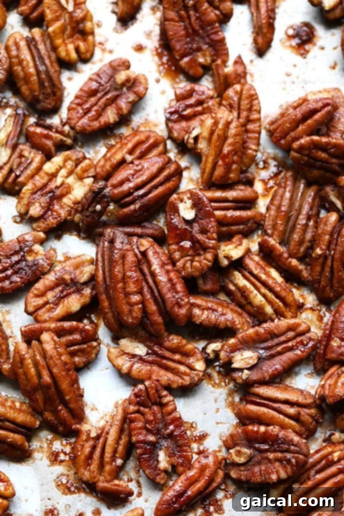 Roasted pecans on baking sheet.