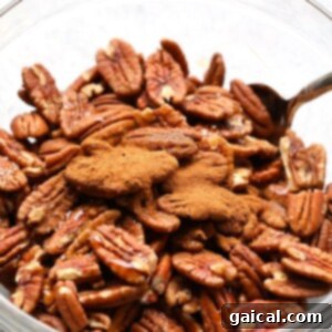 Roasted pecans in a glass bowl.
