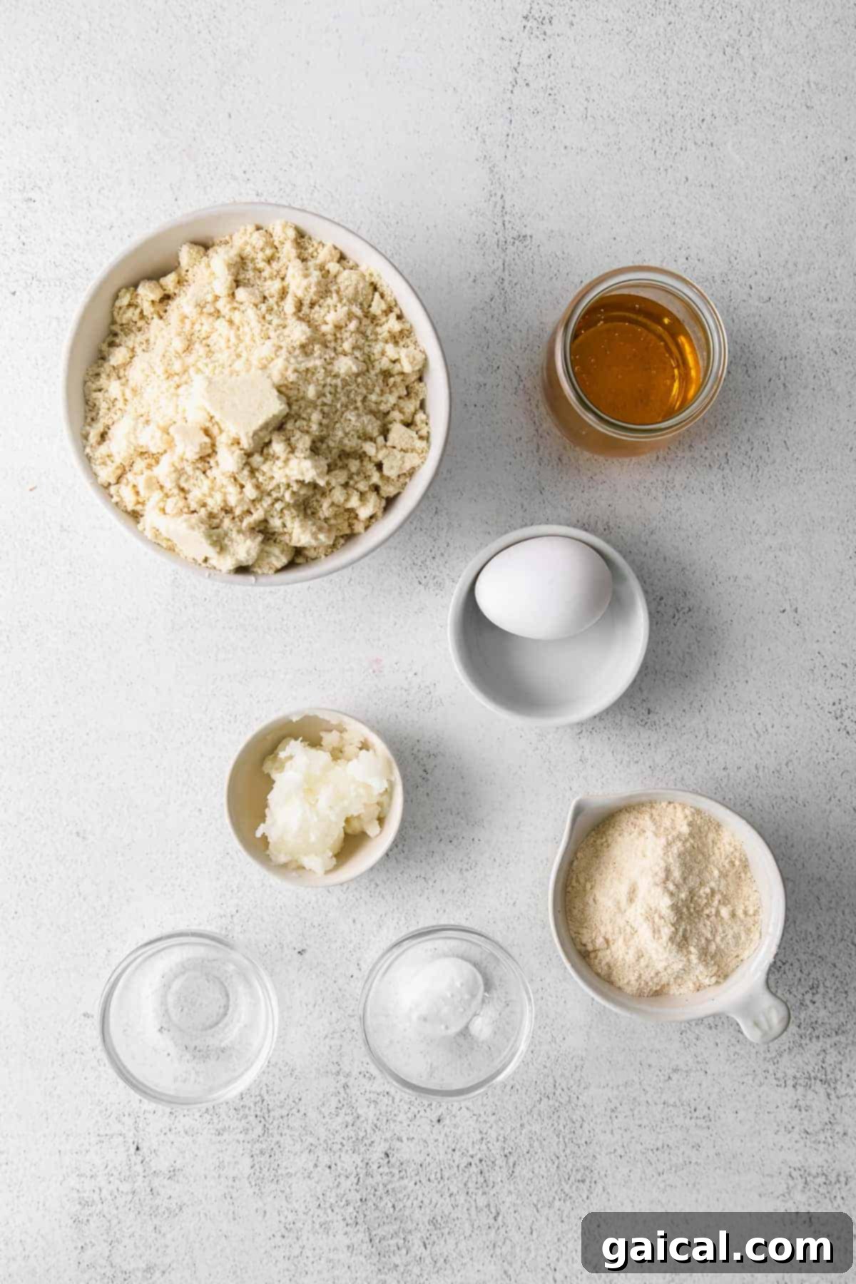 Key Ingredients for Healthy Almond Flour Sugar Cookies A selection of high-quality baking ingredients, including almond flour, coconut flour, honey, and eggs, arranged neatly on a kitchen countertop.